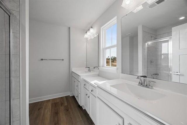 bathroom with vanity, hardwood / wood-style floors, and an enclosed shower