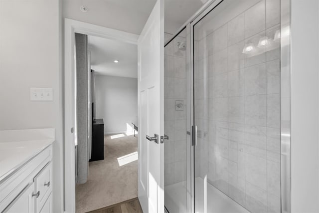 bathroom with vanity, hardwood / wood-style floors, and walk in shower