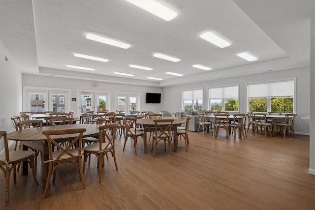 dining space with hardwood / wood-style flooring and french doors