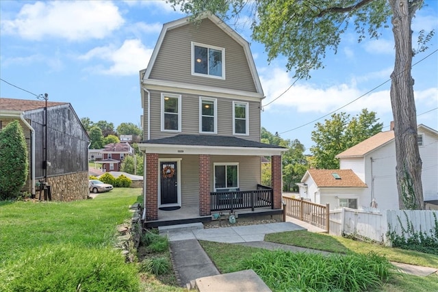 view of front of property featuring a front lawn and covered porch