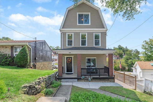 view of front of house with covered porch and a front yard