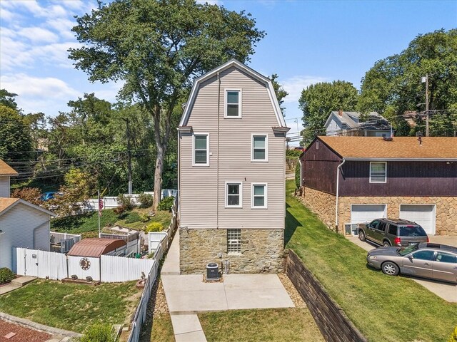 view of home's exterior with a garage and a yard