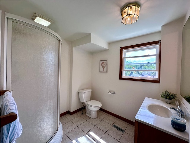 bathroom featuring vanity, toilet, a shower with shower door, and tile patterned flooring