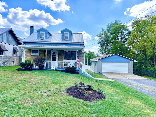 view of front of home with an outdoor structure, a garage, a front lawn, and covered porch