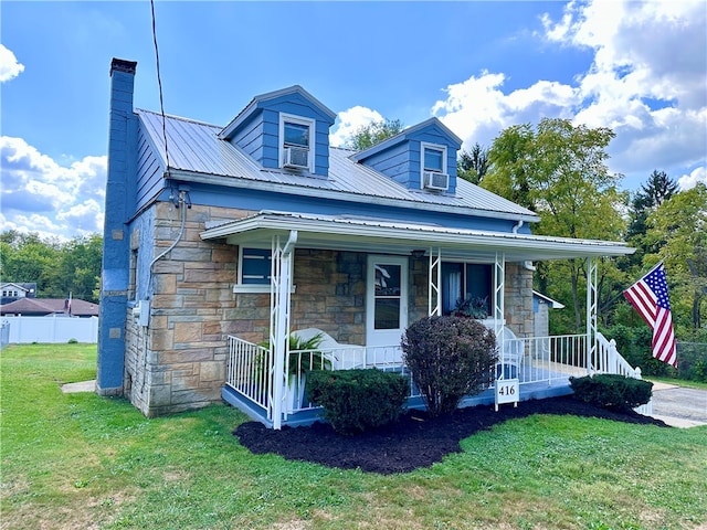 view of front of home featuring cooling unit, a front yard, and a porch