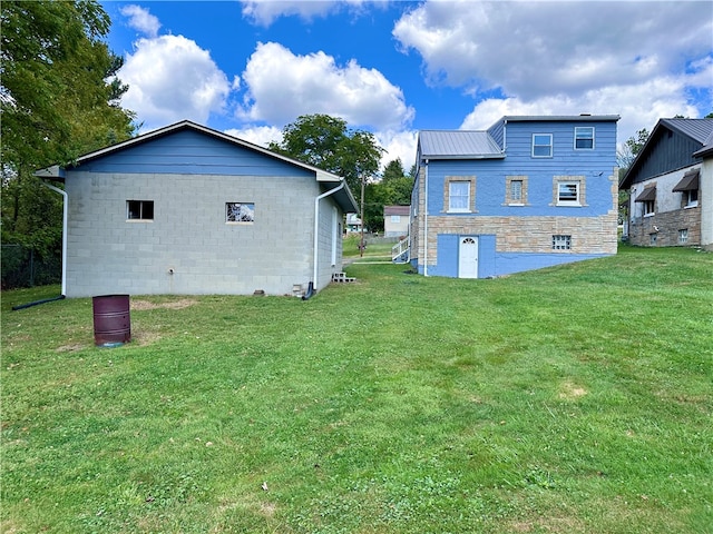 rear view of house with a yard