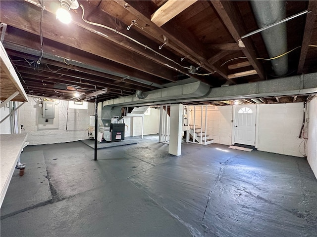 basement with water heater, electric panel, and heating unit