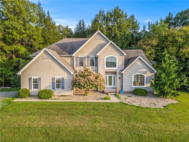 view of property featuring a front lawn