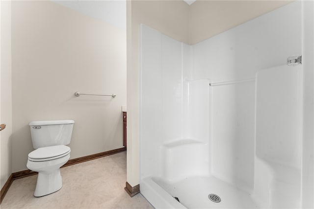 bathroom featuring walk in shower, toilet, and vanity