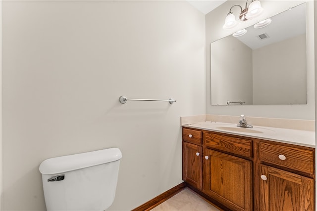 bathroom with tile patterned flooring, toilet, and vanity