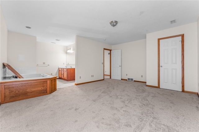 unfurnished living room featuring light colored carpet