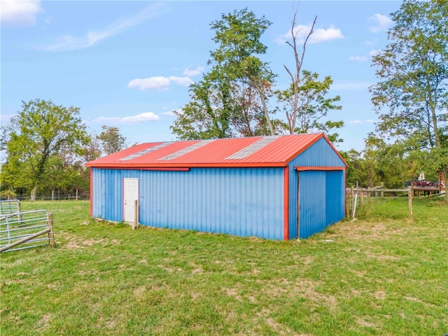 view of outbuilding with a yard