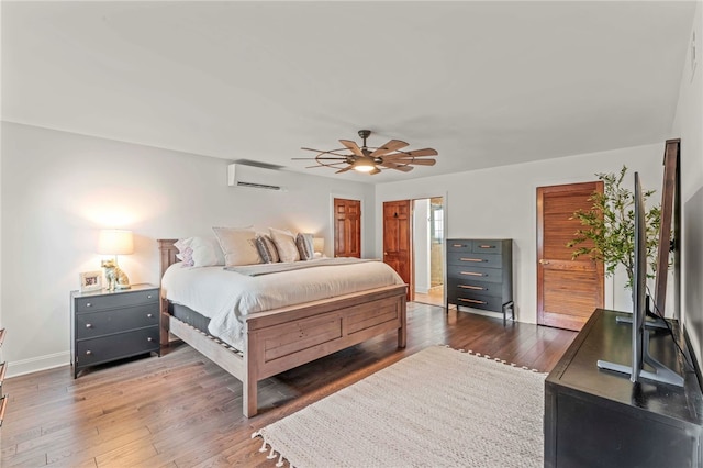 bedroom with dark wood-type flooring, a wall mounted air conditioner, and ceiling fan