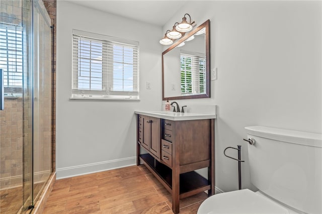 bathroom with vanity, toilet, hardwood / wood-style floors, and walk in shower