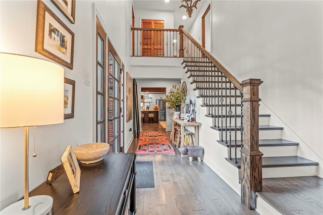 foyer with a high ceiling and hardwood / wood-style floors