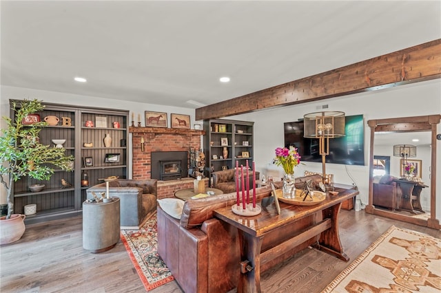 living room with wood-type flooring and a fireplace