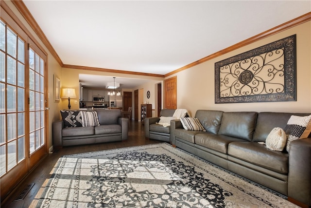 living room featuring a wealth of natural light, crown molding, and dark hardwood / wood-style floors