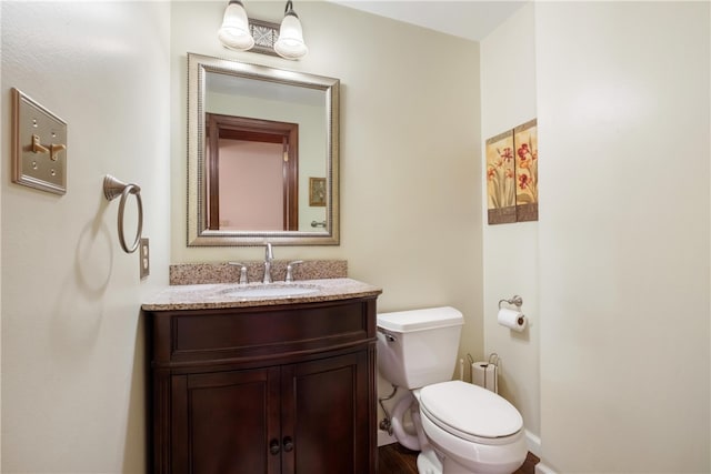 bathroom featuring toilet and vanity