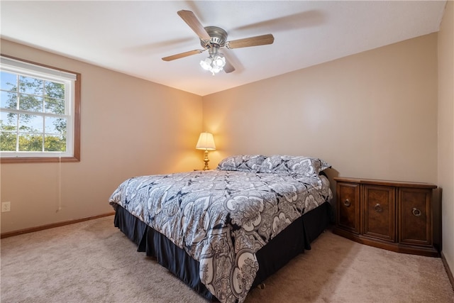 bedroom featuring light colored carpet and ceiling fan