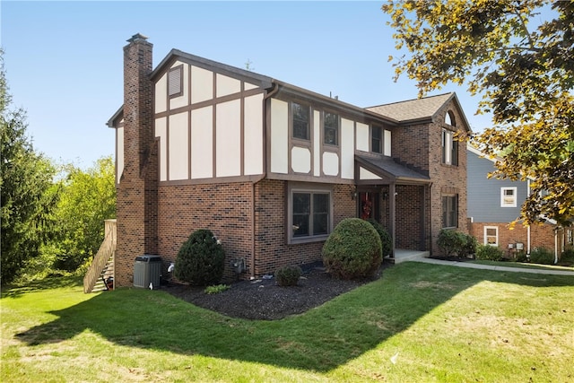 view of front of home featuring a front lawn and cooling unit