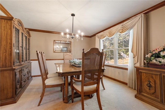 dining space with crown molding, an inviting chandelier, and light colored carpet