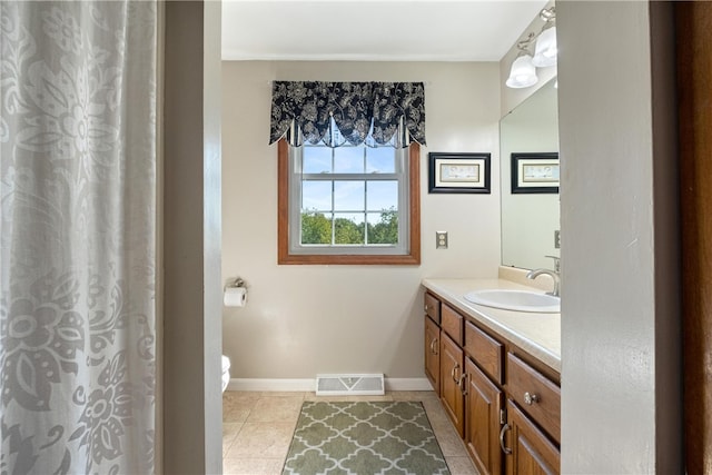 bathroom featuring tile patterned floors, toilet, and vanity