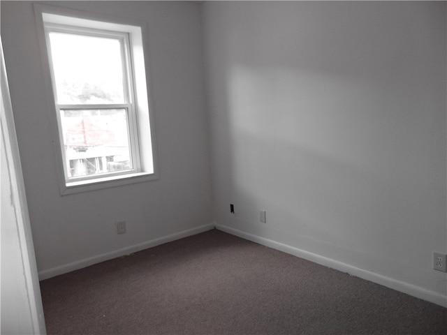 carpeted spare room featuring a wealth of natural light