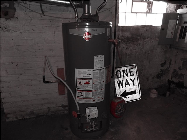 utility room featuring gas water heater and electric panel