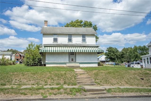 view of front facade with a front lawn and a porch