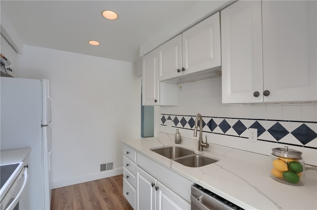 kitchen with sink, white cabinetry, white appliances, and tasteful backsplash