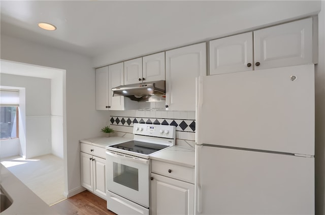 kitchen featuring light hardwood / wood-style floors, white appliances, white cabinets, and tasteful backsplash