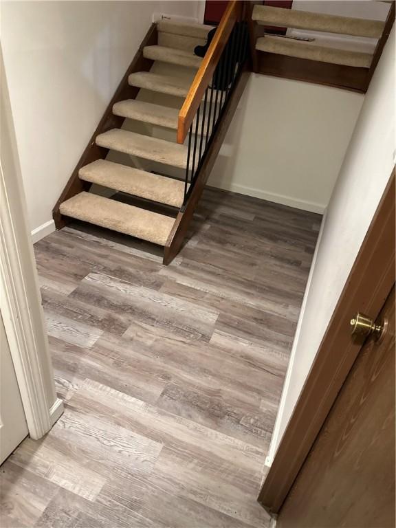 stairway featuring hardwood / wood-style flooring