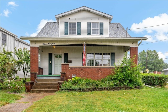 view of front of home featuring a front lawn and covered porch