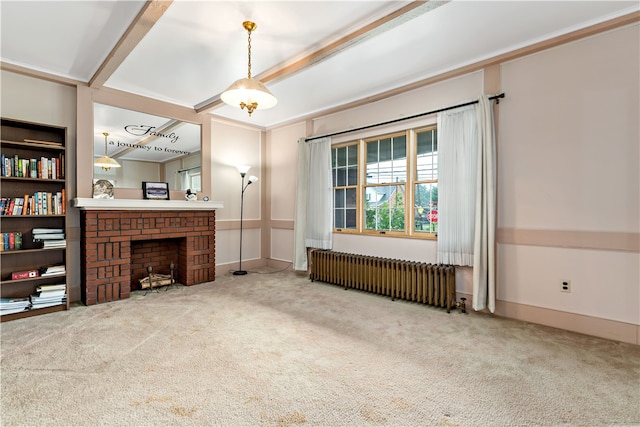 living room with crown molding, carpet, radiator, and a brick fireplace