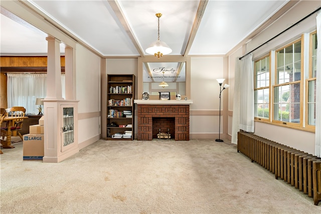 living room with radiator heating unit, a fireplace, ornate columns, and carpet flooring