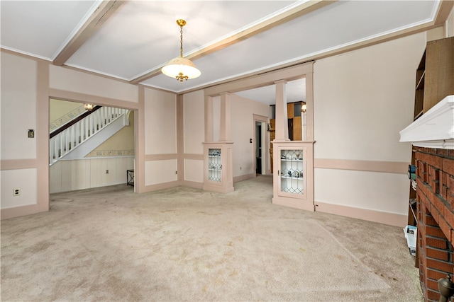 unfurnished living room with crown molding, carpet flooring, and a fireplace