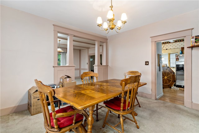 carpeted dining space with a chandelier