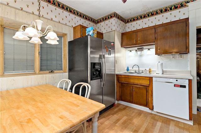 kitchen featuring a chandelier, decorative light fixtures, dishwasher, stainless steel fridge with ice dispenser, and light hardwood / wood-style floors