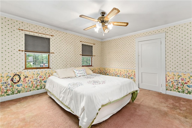 carpeted bedroom featuring ceiling fan and crown molding