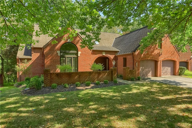 view of front facade with a front lawn and a garage