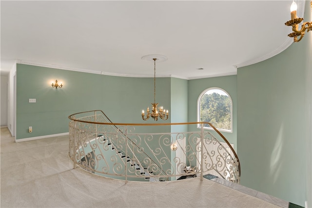 corridor featuring carpet, an inviting chandelier, and crown molding