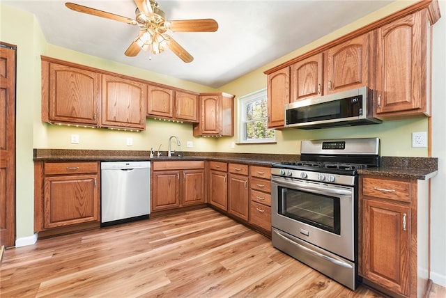 kitchen featuring ceiling fan, light hardwood / wood-style floors, sink, and appliances with stainless steel finishes