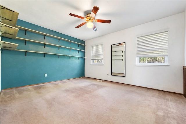 spare room featuring light colored carpet and ceiling fan