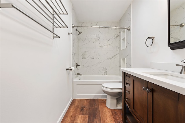 full bathroom featuring hardwood / wood-style floors, vanity, toilet, and tiled shower / bath