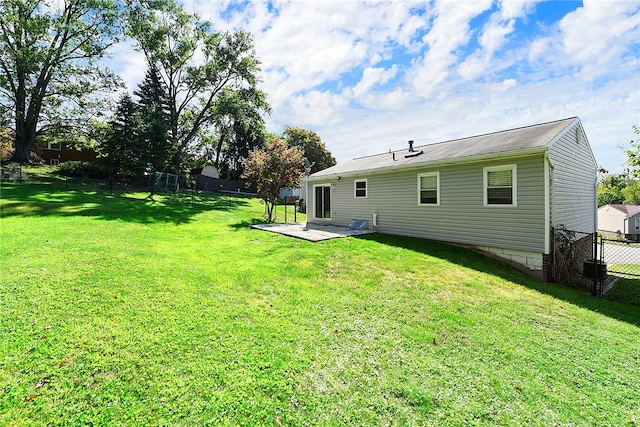 rear view of property with a yard and a patio