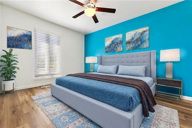 bedroom with ceiling fan and wood-type flooring