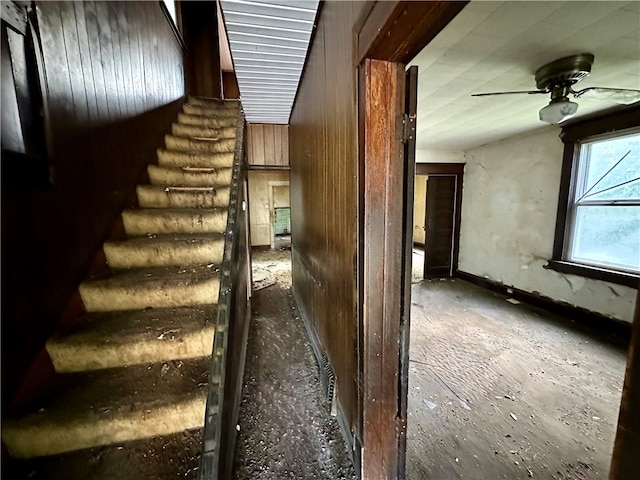 staircase featuring ceiling fan