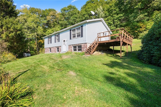 exterior space featuring a lawn and a wooden deck