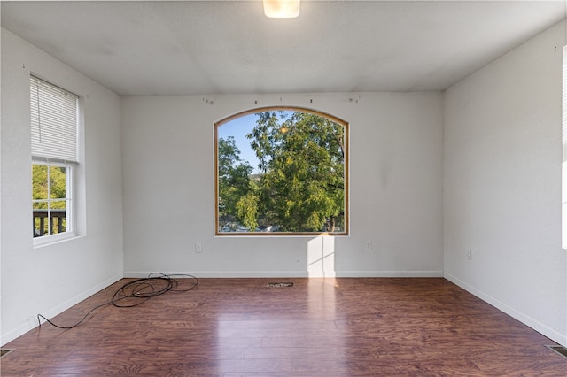 unfurnished room with dark hardwood / wood-style flooring