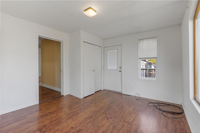 unfurnished bedroom featuring dark wood-type flooring and a closet